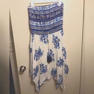 Strapless dress with blue floral print and handkerchief hem skirt